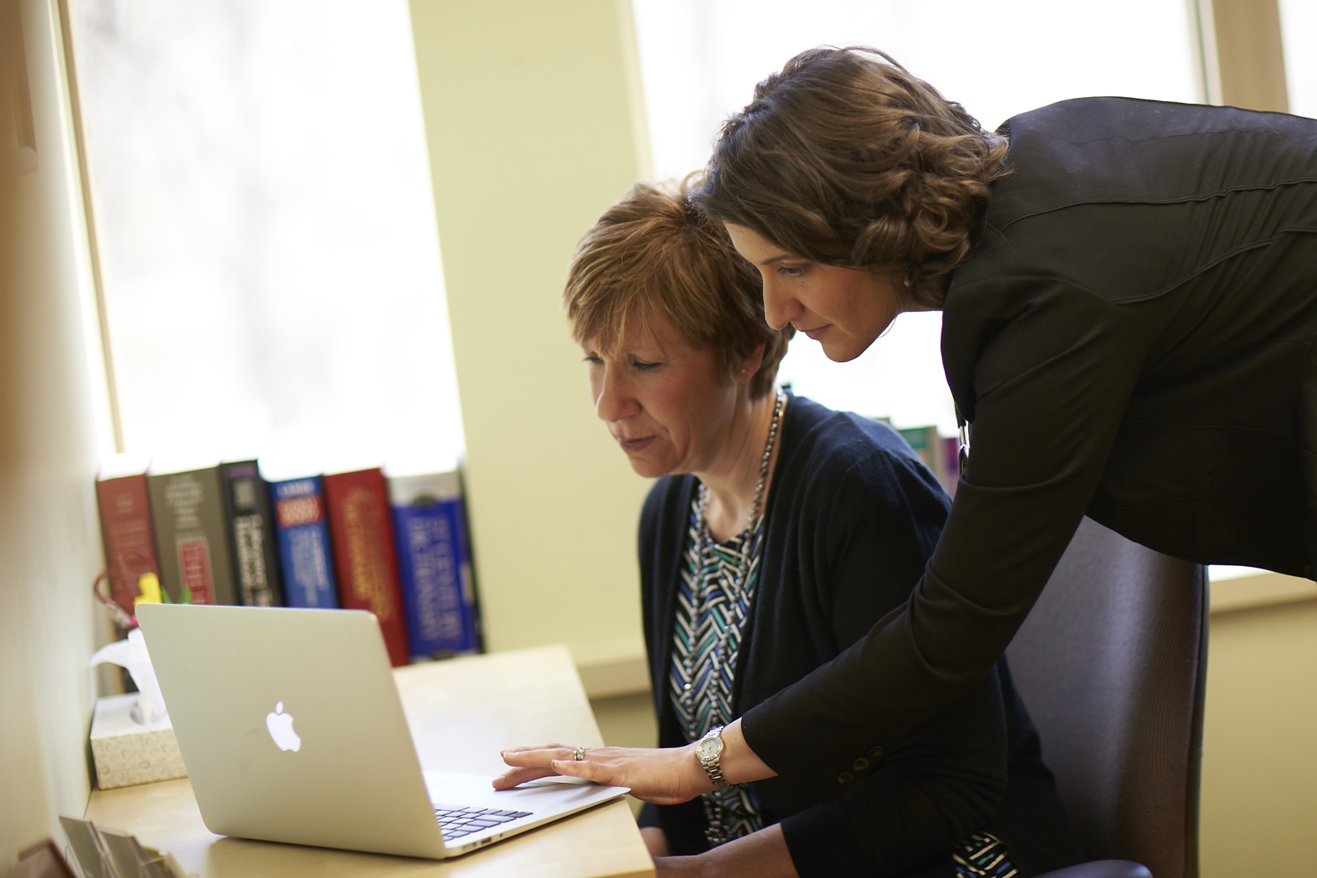 Doctor Samantha Eagle at a computer with an assistant.