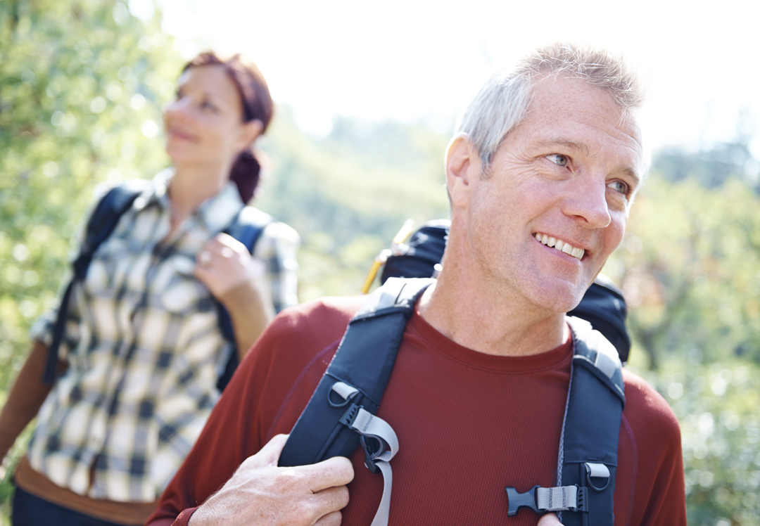  A healthy mature man hikes with his wife.