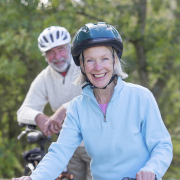 A healthy mature woman gardens with her husband.